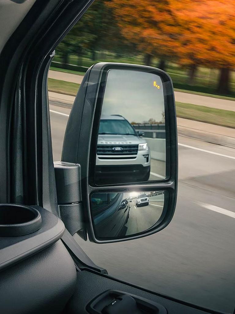 A mirror showing the Blind Spot Information System in action