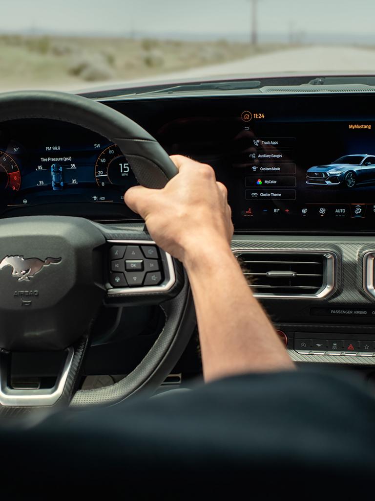 Person driving a 2026 Ford Mustang® GT Premium fastback on a highway