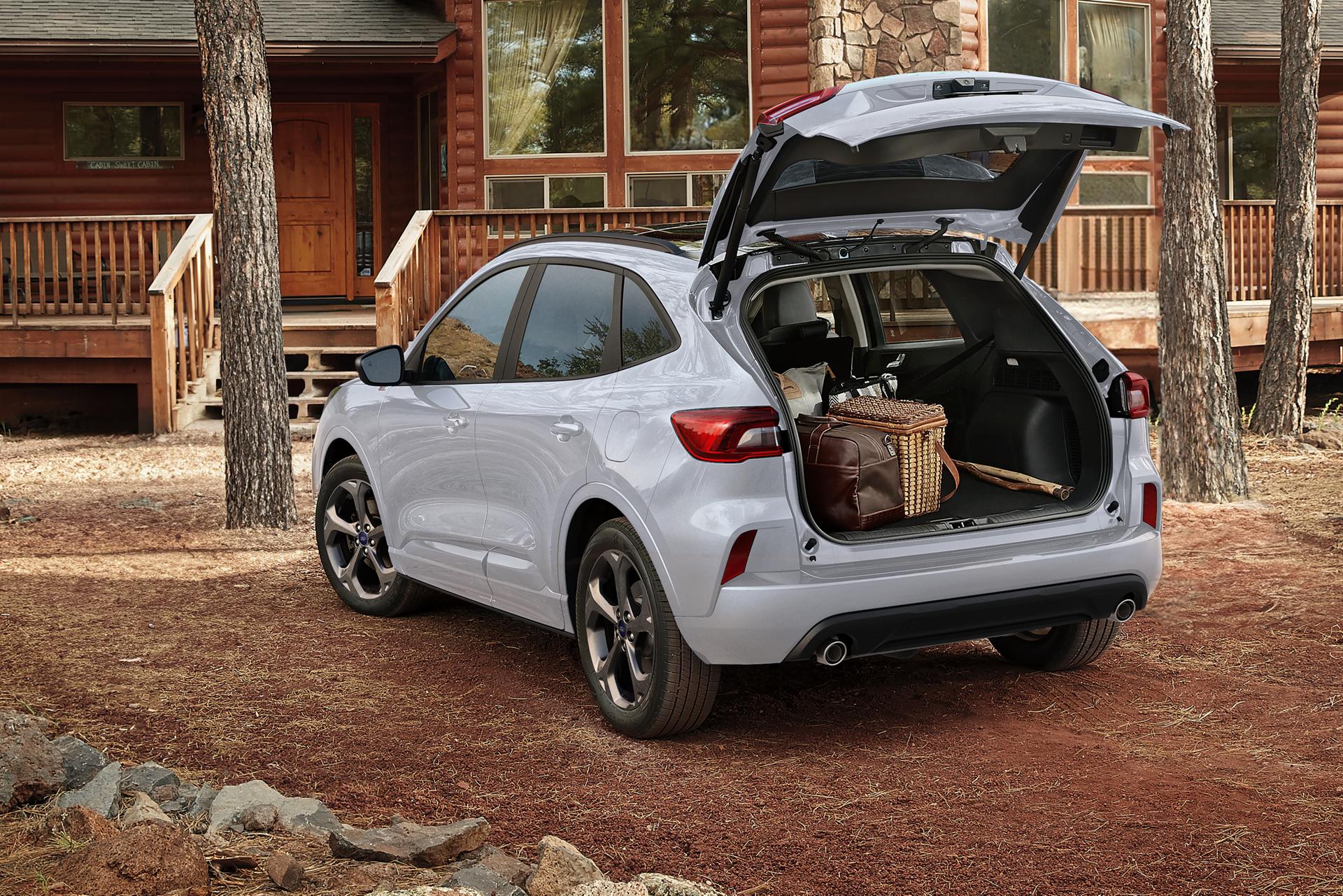2026 Ford Escape® SUV parked outside a cabin with the power liftgate open