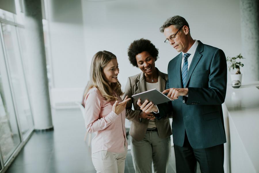 Group of business people using a tablet.