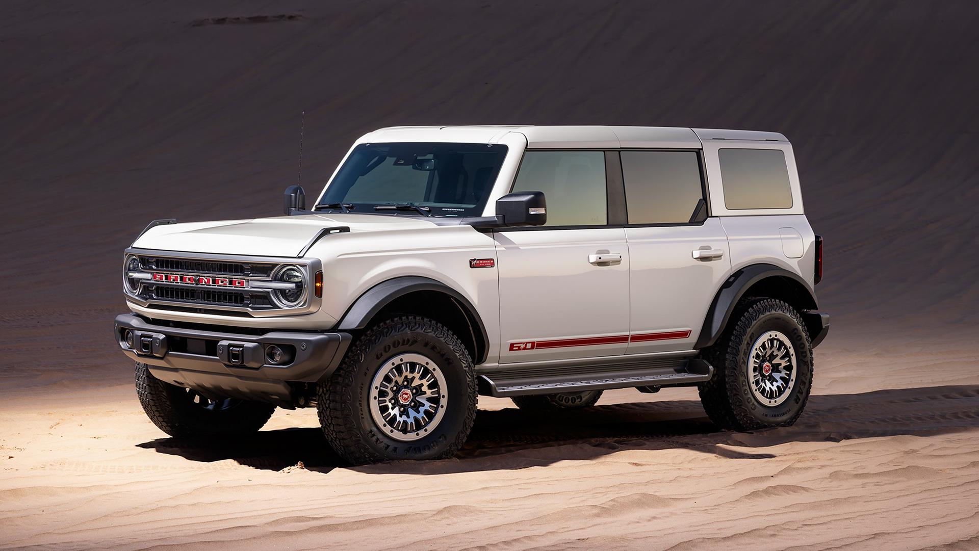 A 2026 Ford Bronco® Outer Banks® SUV with the available 60th Anniversary Package parked on a sandy expanse