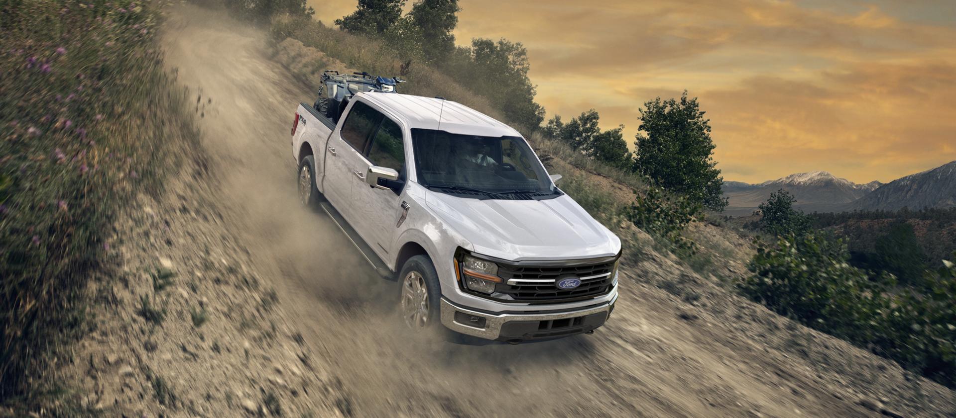 F-150 driving down a dirt slope.