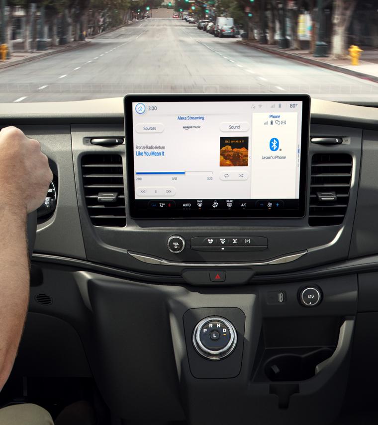 Hands on the wheel next to the dashboard computer display
