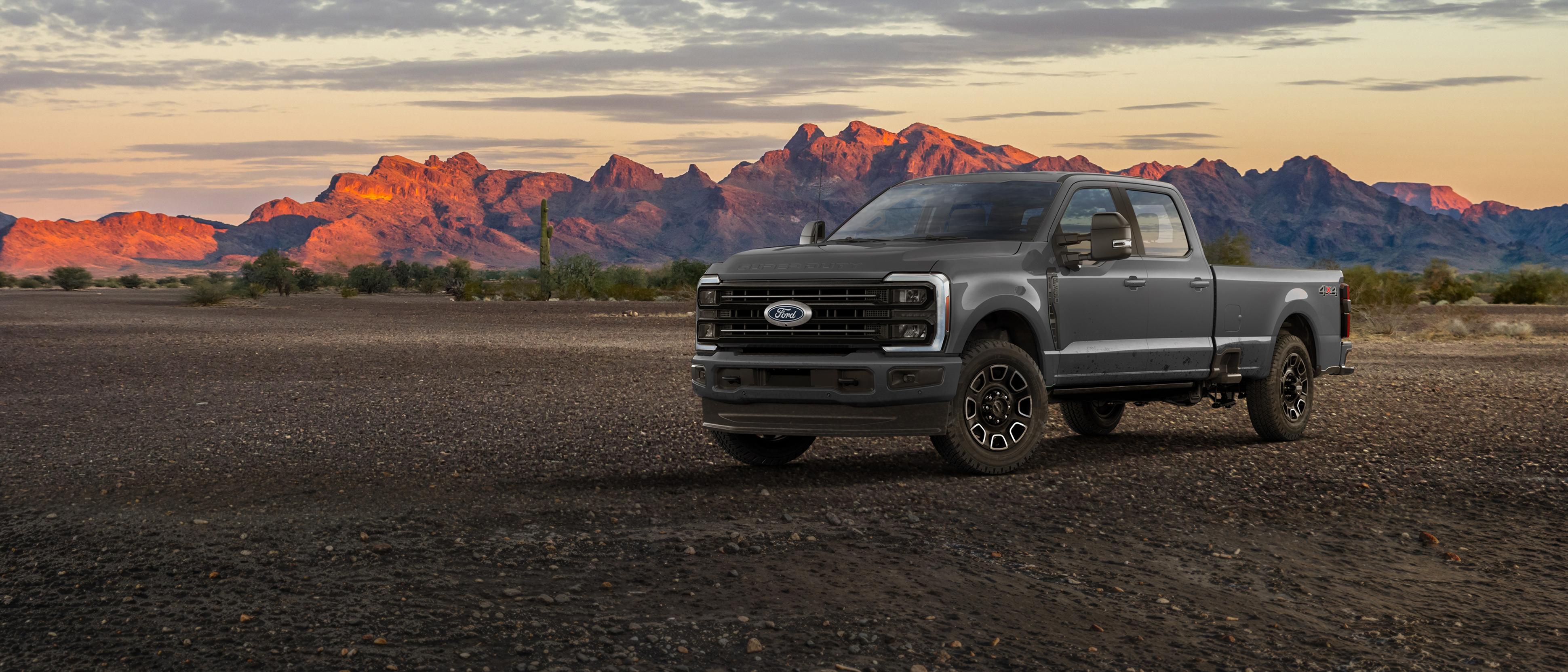 2027 Ford Super Duty® F-350® Platinum® truck parked on a dirt road in the mountains