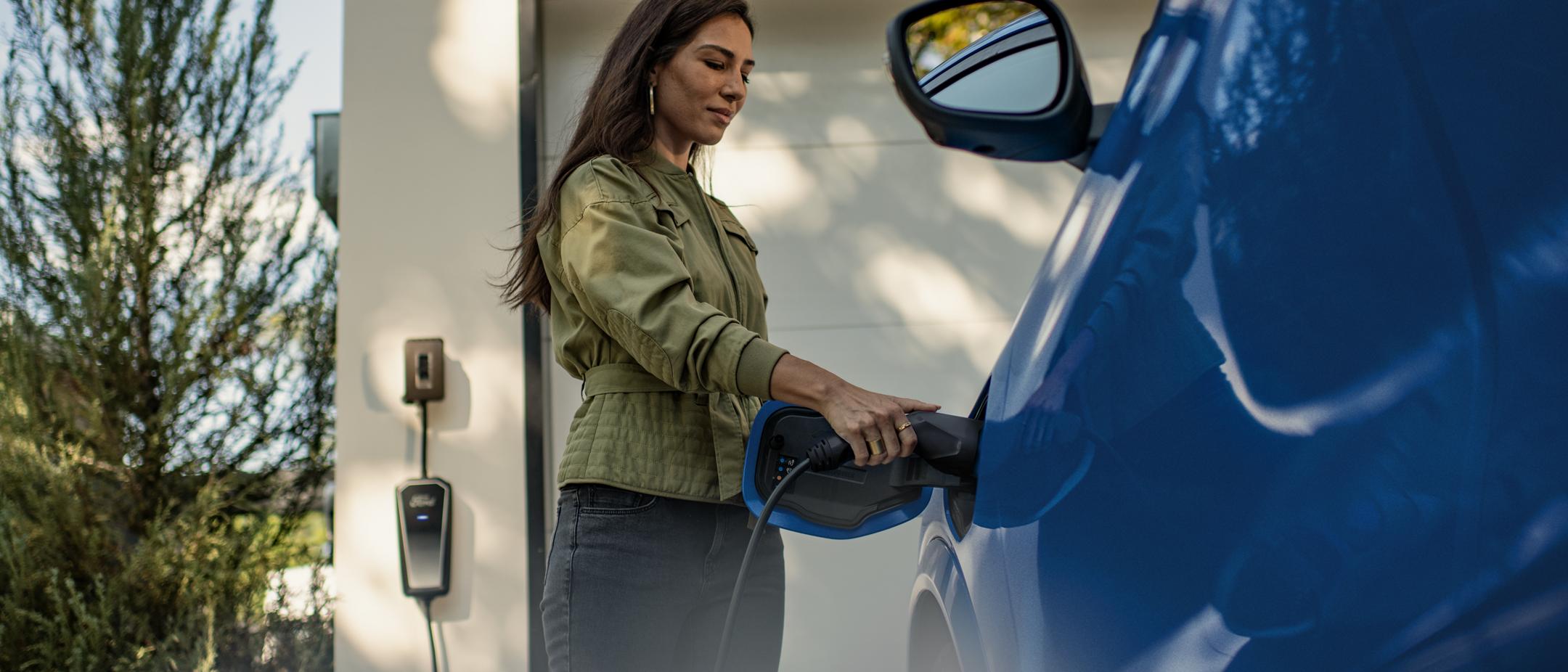Person connects a Mustang Mach-E into a home charge station.