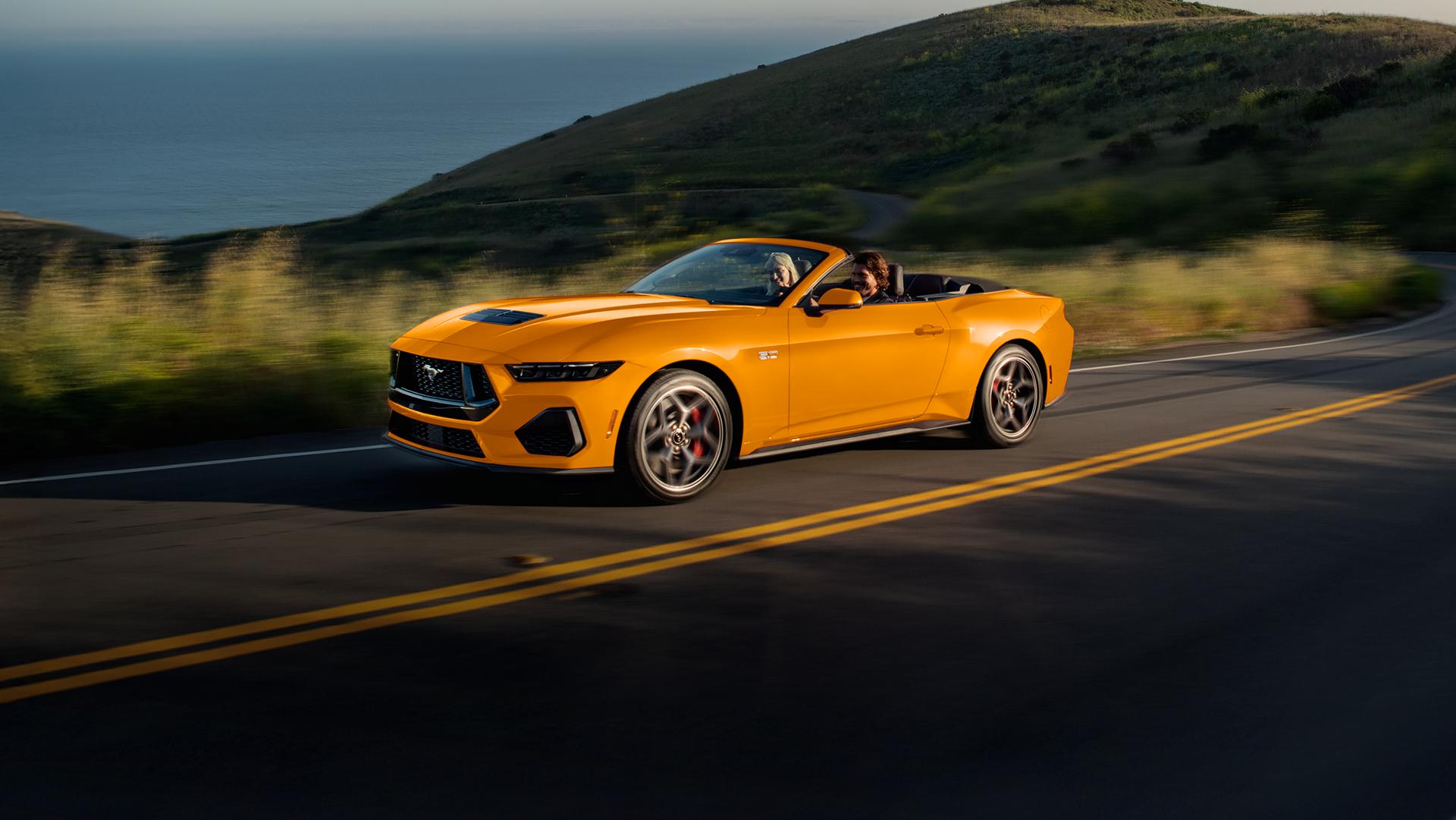 Two people driving in a 2026 Ford Mustang® GT convertible