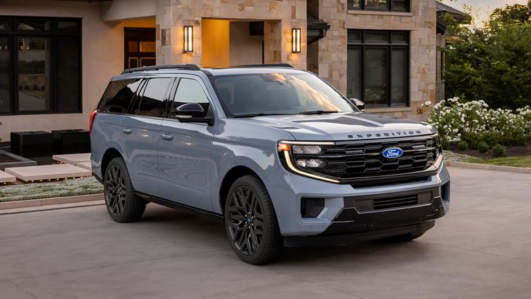 2027 Ford Expedition® Platinum™ SUV with available Stealth Performance Package parked in a driveway