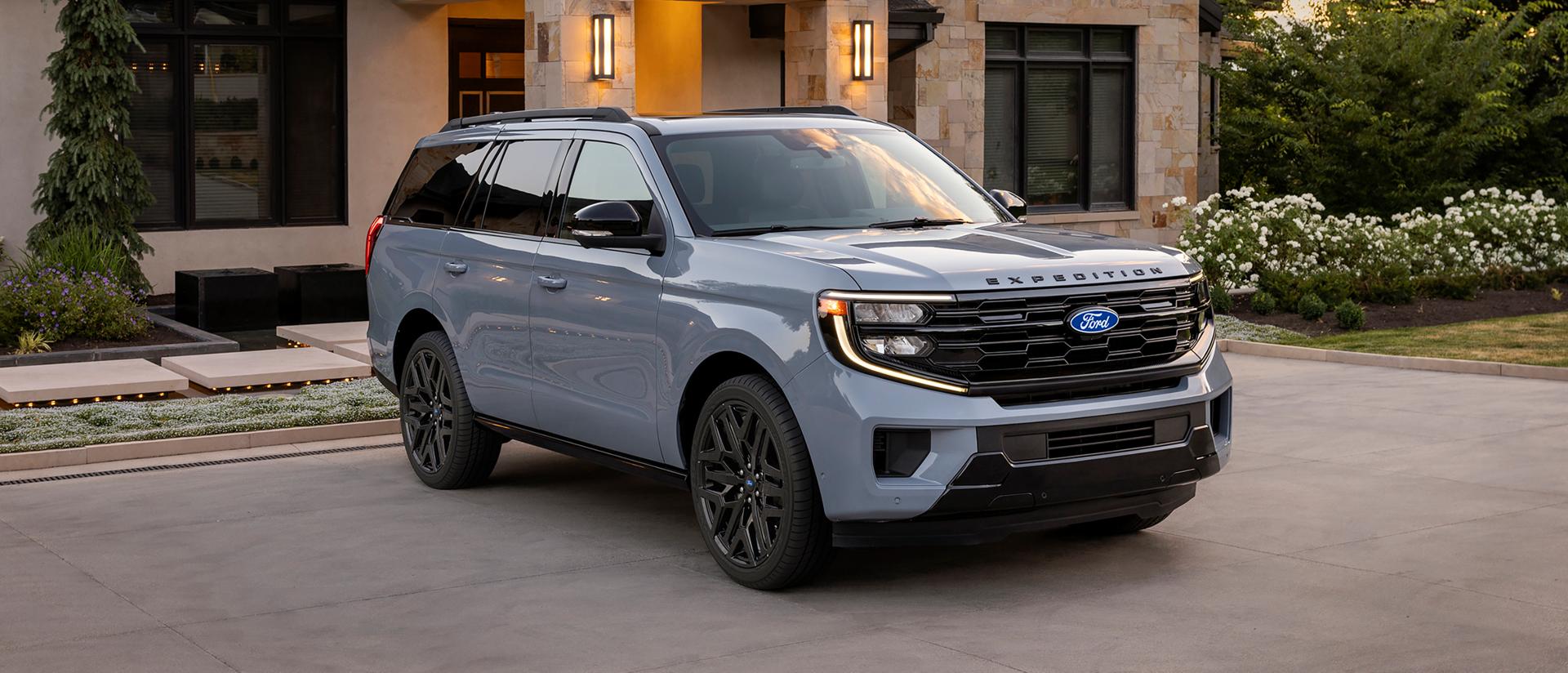 2027 Ford Expedition® Platinum™ SUV with available Stealth Performance Package parked in a driveway