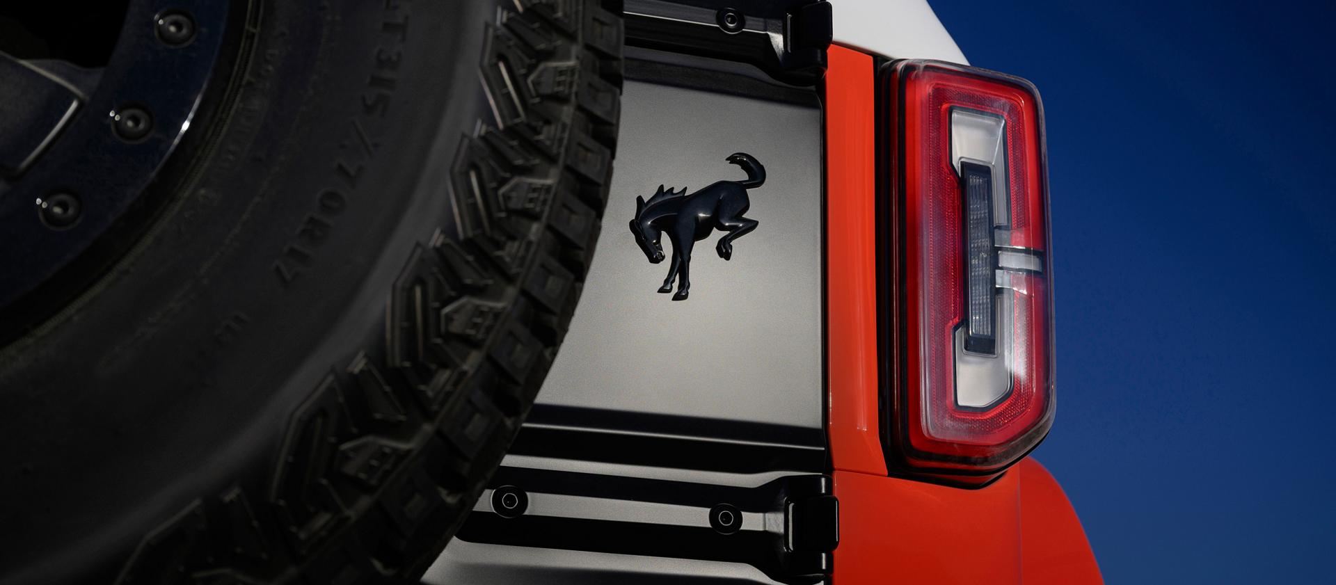 A close-up of the Bronco badge on the rear swing gate of a 2026 Ford Bronco® Stroppe Edition SUV