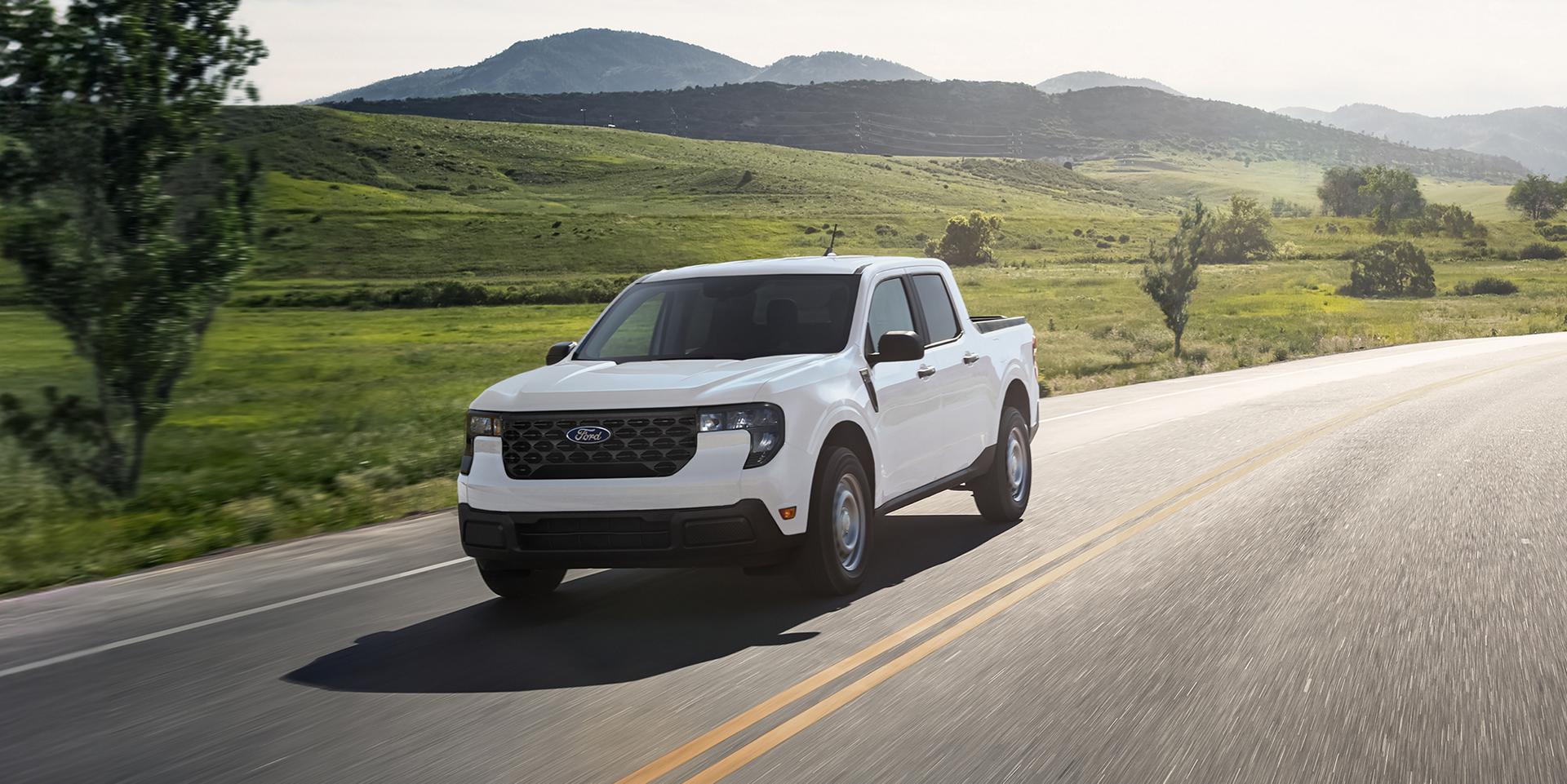 2026 Ford Maverick® pickup in Oxford White being driven on a country highway
