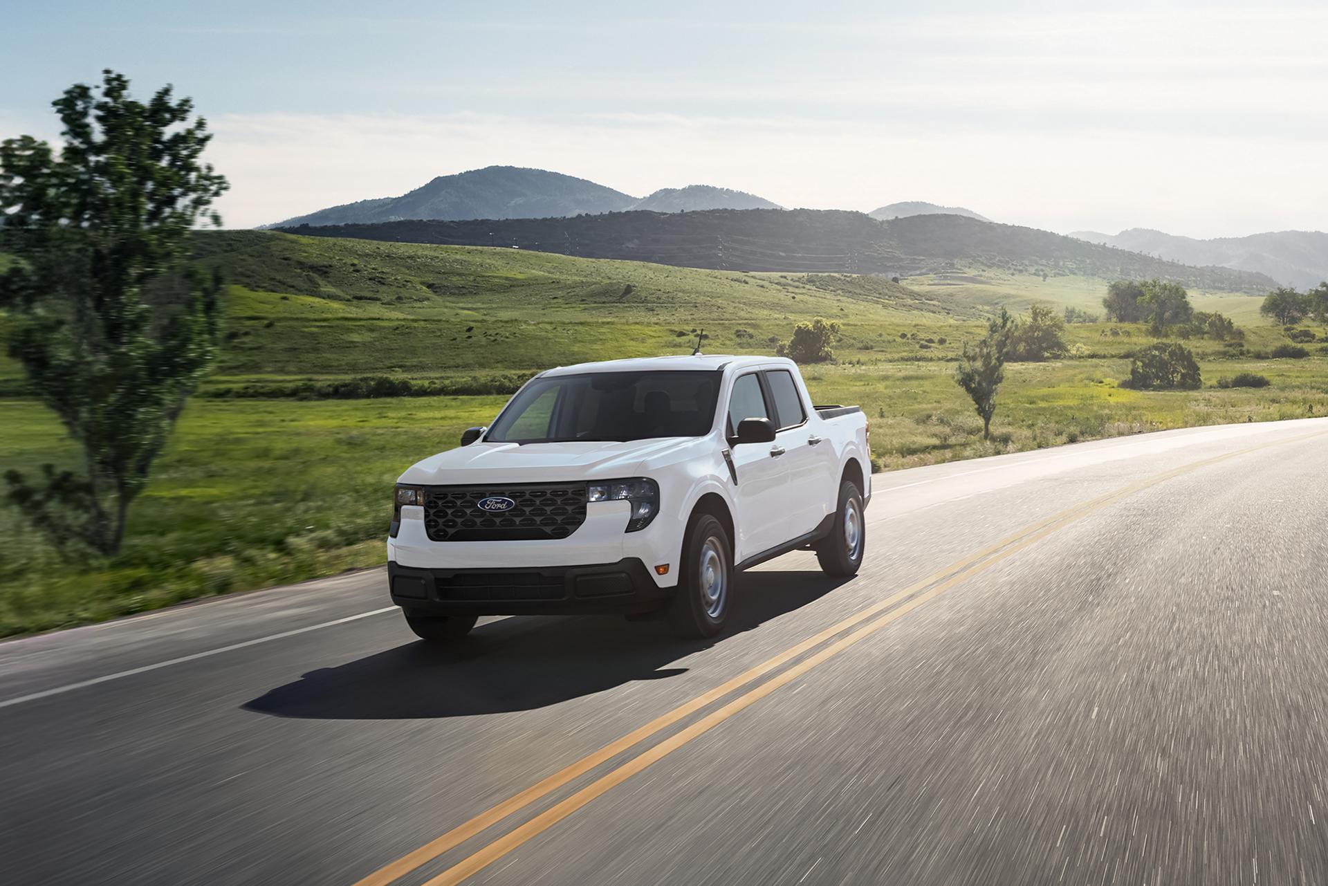 2026 Ford Maverick® pickup in Oxford White being driven on a country highway