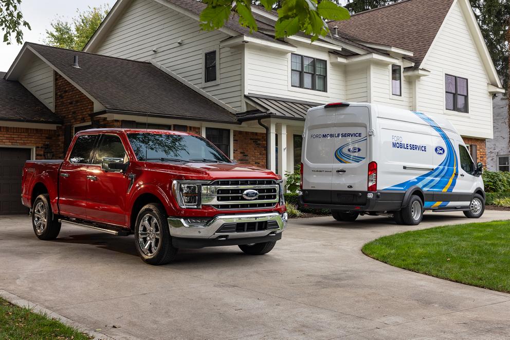 A Ford Mobile Service vehicle parked in front of a home.