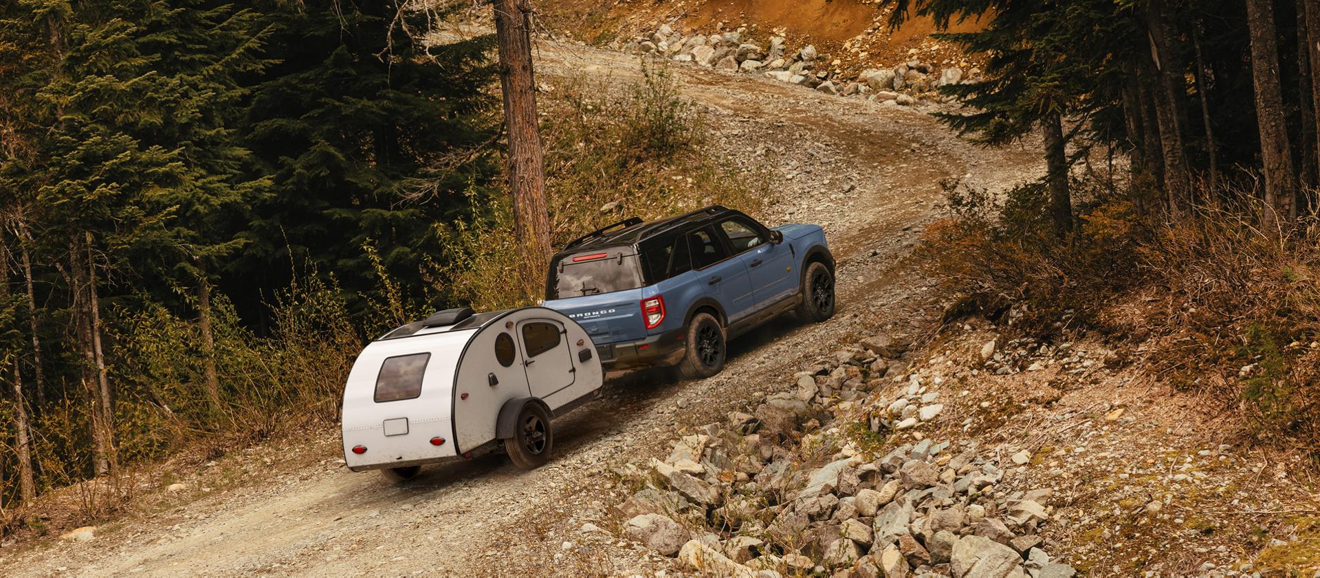 2026 Ford Bronco Sport® SUV towing a trailer on a mountain gravel road