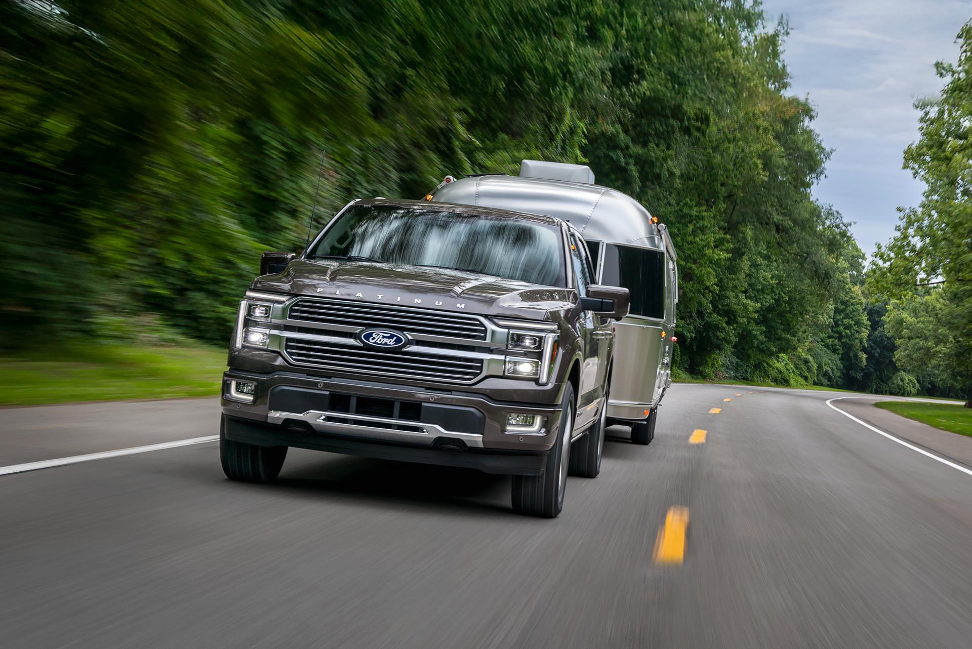 2026 Ford F-150 Platinum® model in Marsh Grey pulling a camper