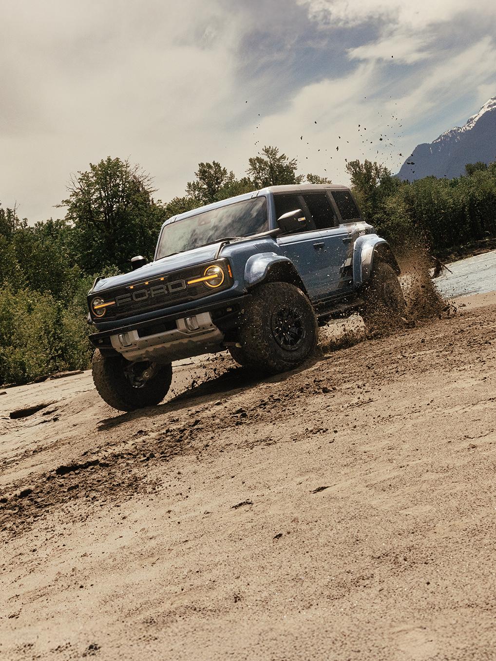 Bronco Raptor driving down a dirt slope.