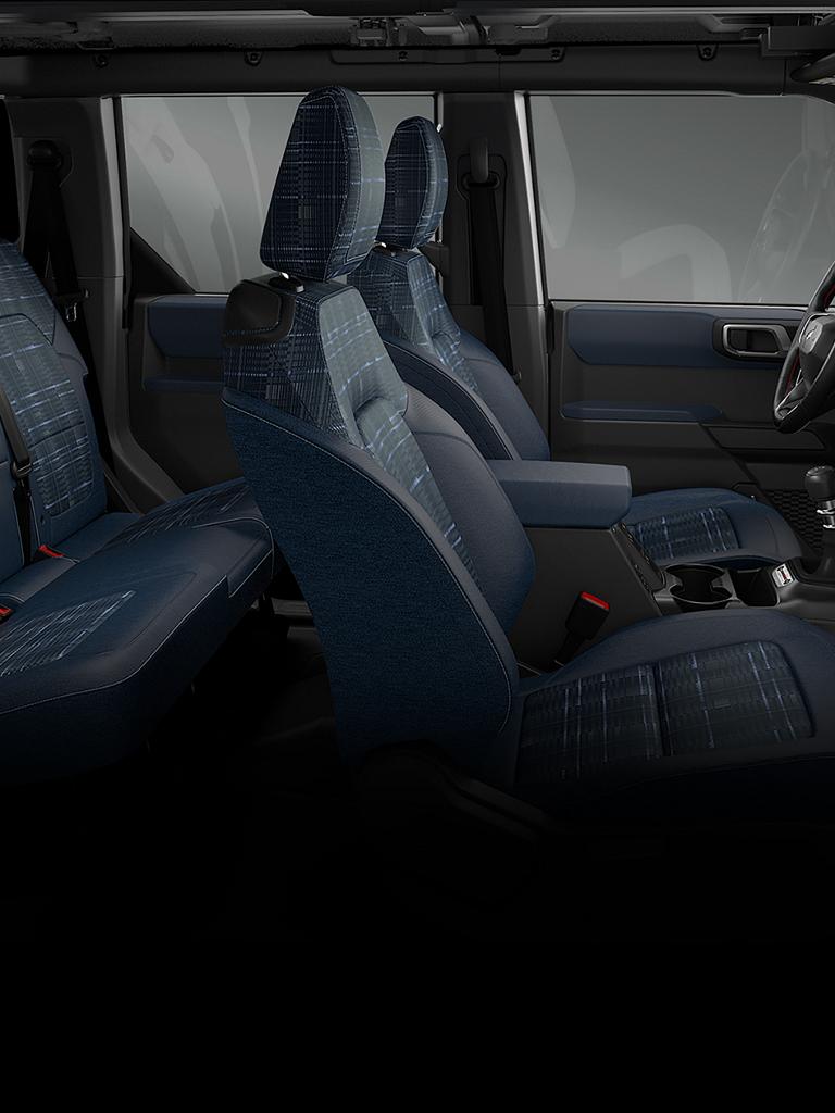 The interior of a 2026 Ford Bronco® Heritage Edition SUV, showing the plaid cloth seats