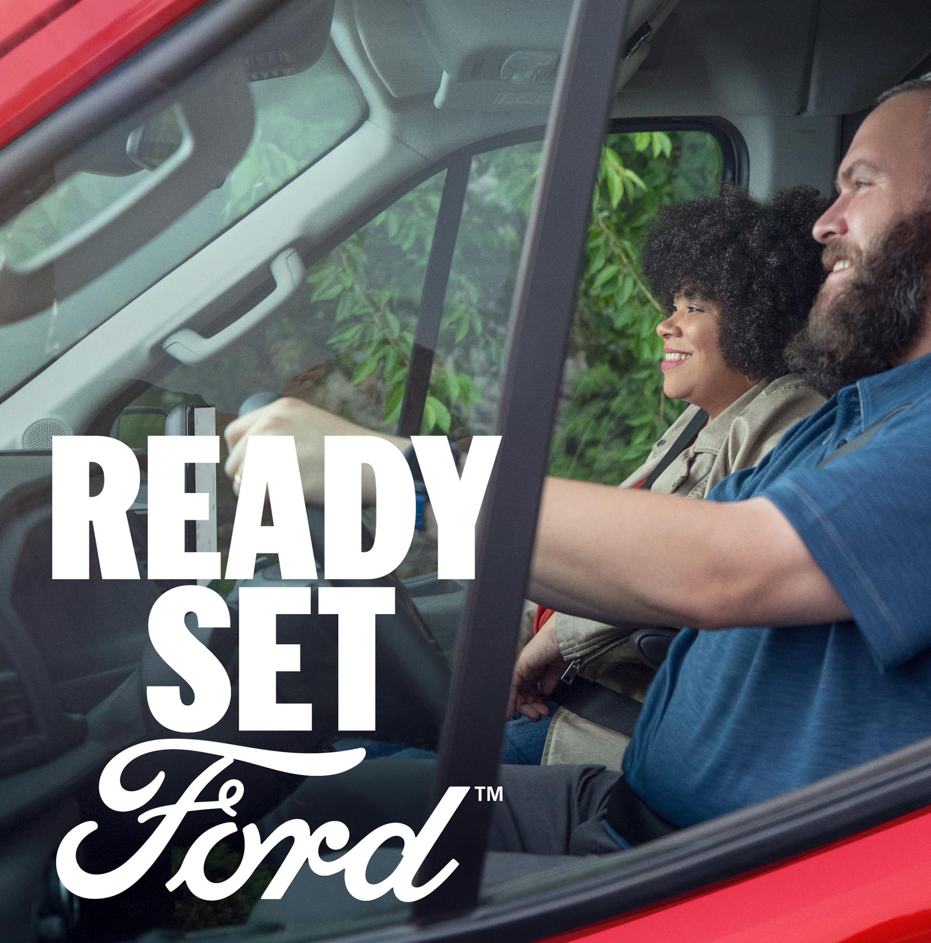 Close up of two people driving in a 2026 Ford Transit® van