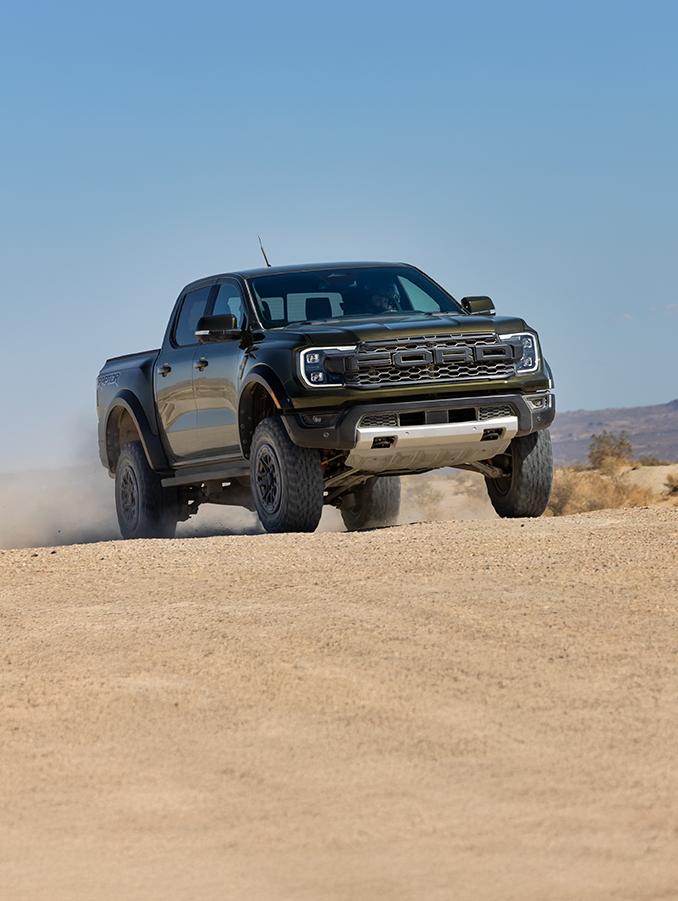 Ranger Raptor driving up a rugged hill.