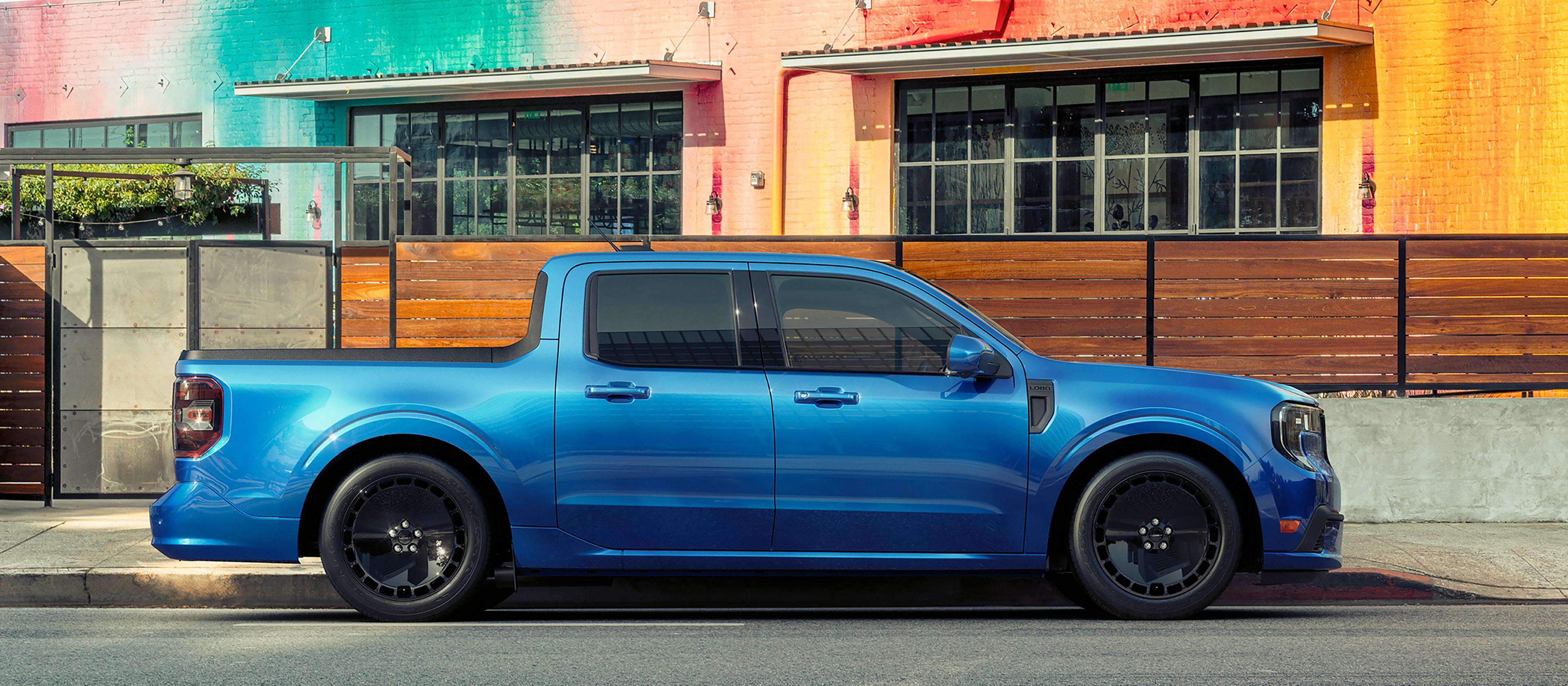 2026 Maverick® Lobo™ pickup parked in front of a colourful building