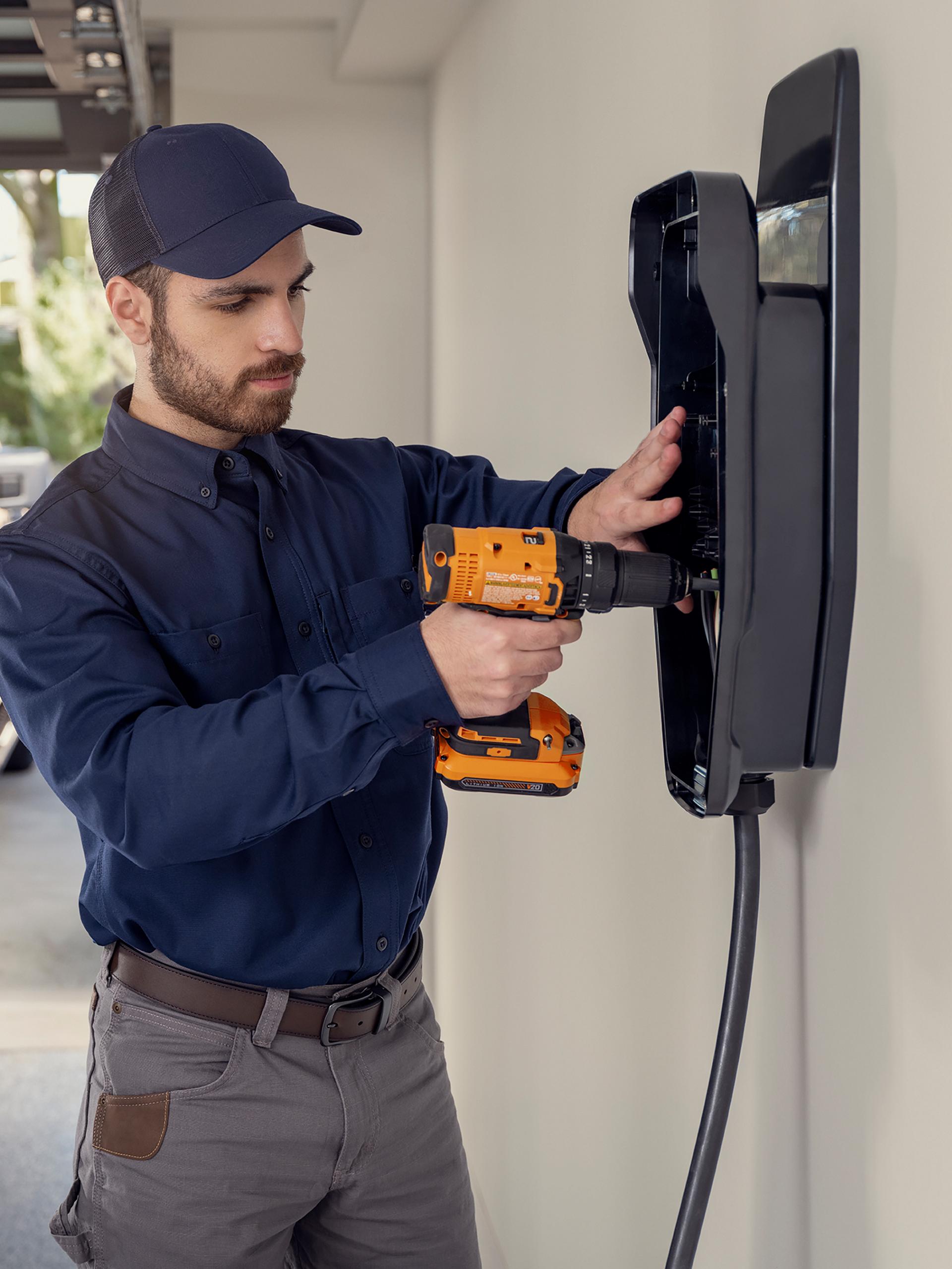 Technician installing a Ford home charger
