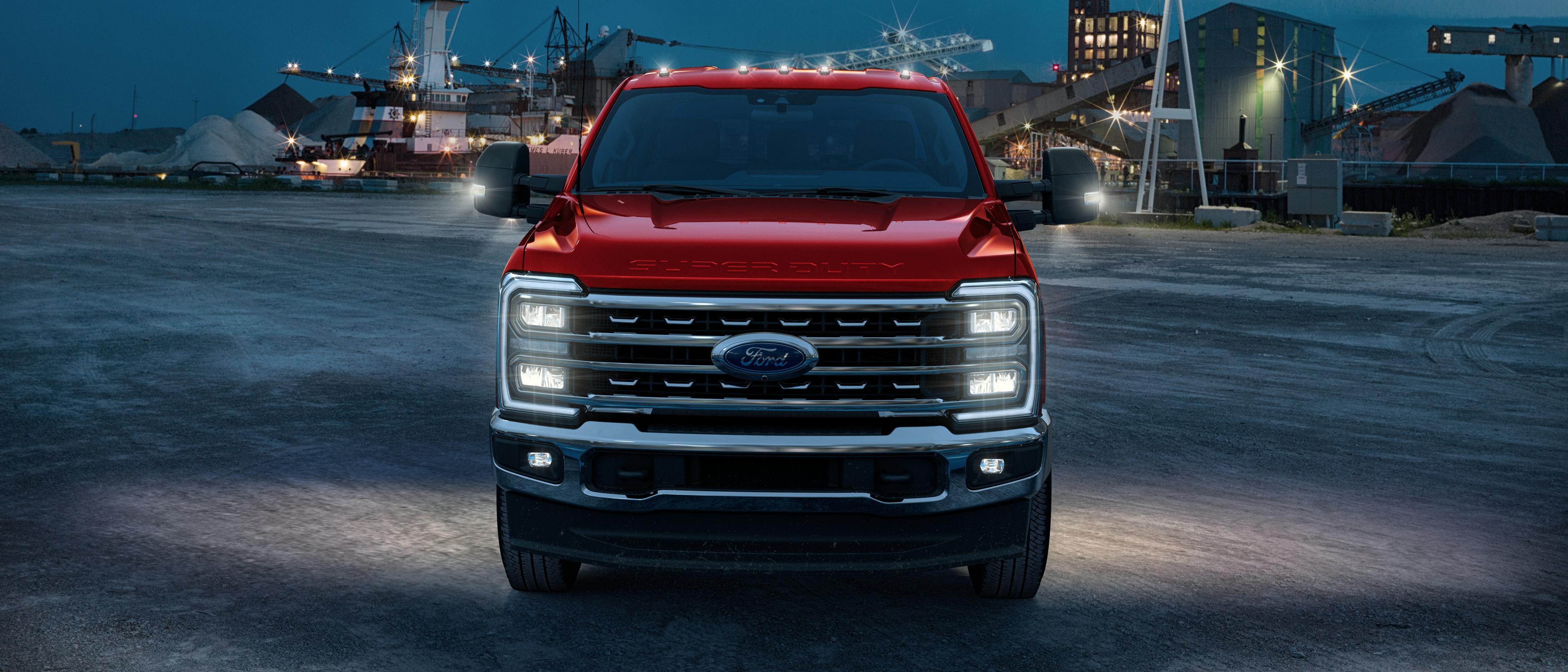 2026 Ford Super Duty® F-450® with the Tremor® Off-Road package parked on a construction site at dusk with its lights on