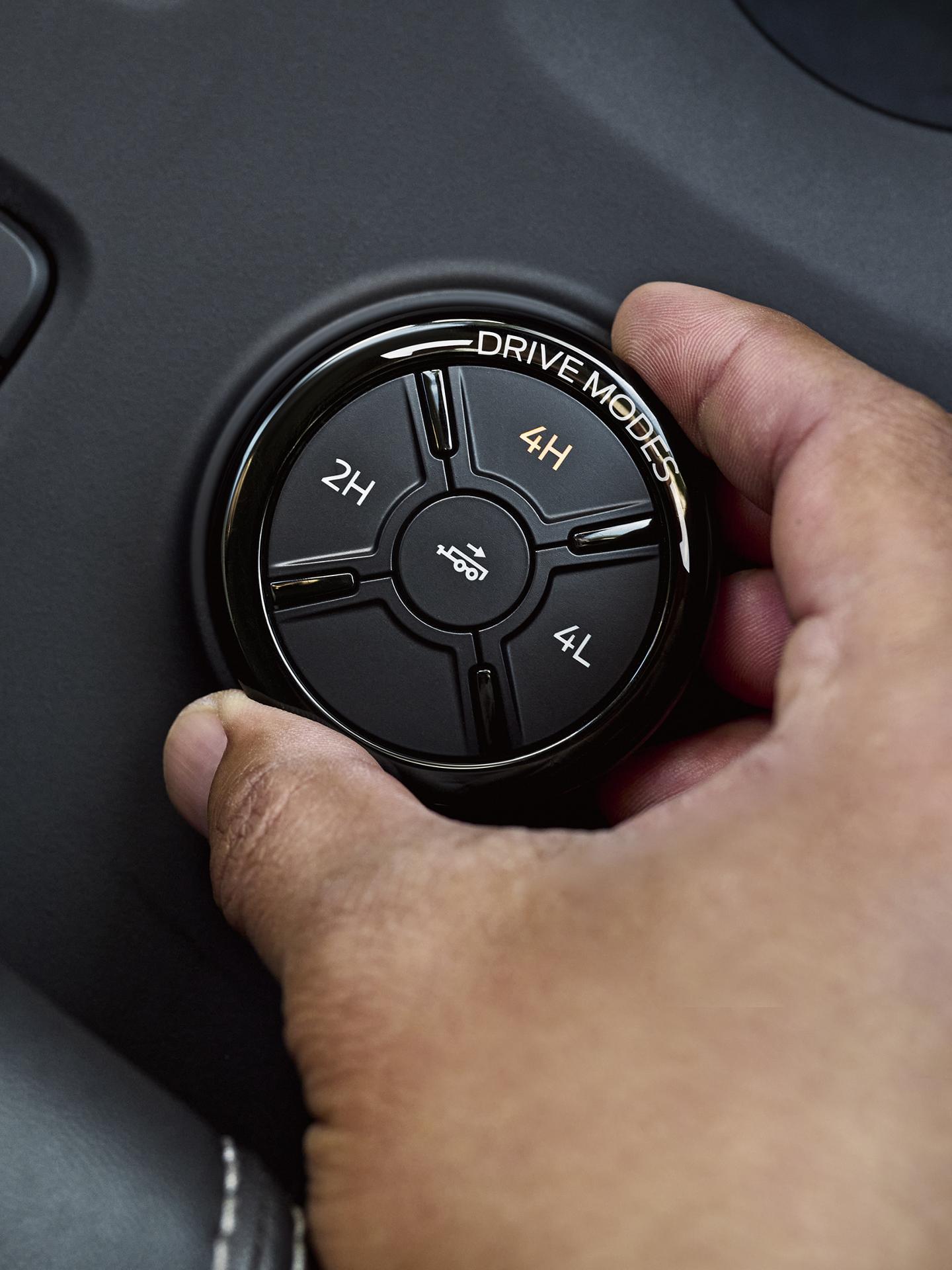 Close-up of a person's hand turning the drive mode dial on their 2026 Ford Ranger® truck