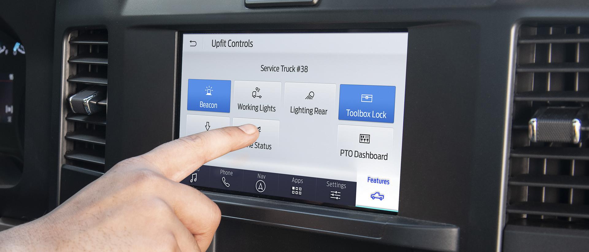 A person using the upfit controls on the eight-inch centre display