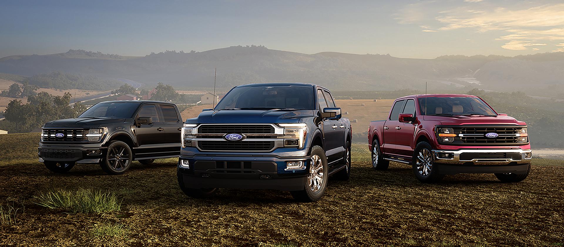 2026 Ford F-150® Lariat®, F-150® Lightning®, and Platinum® models parked on a desert plain at dusk