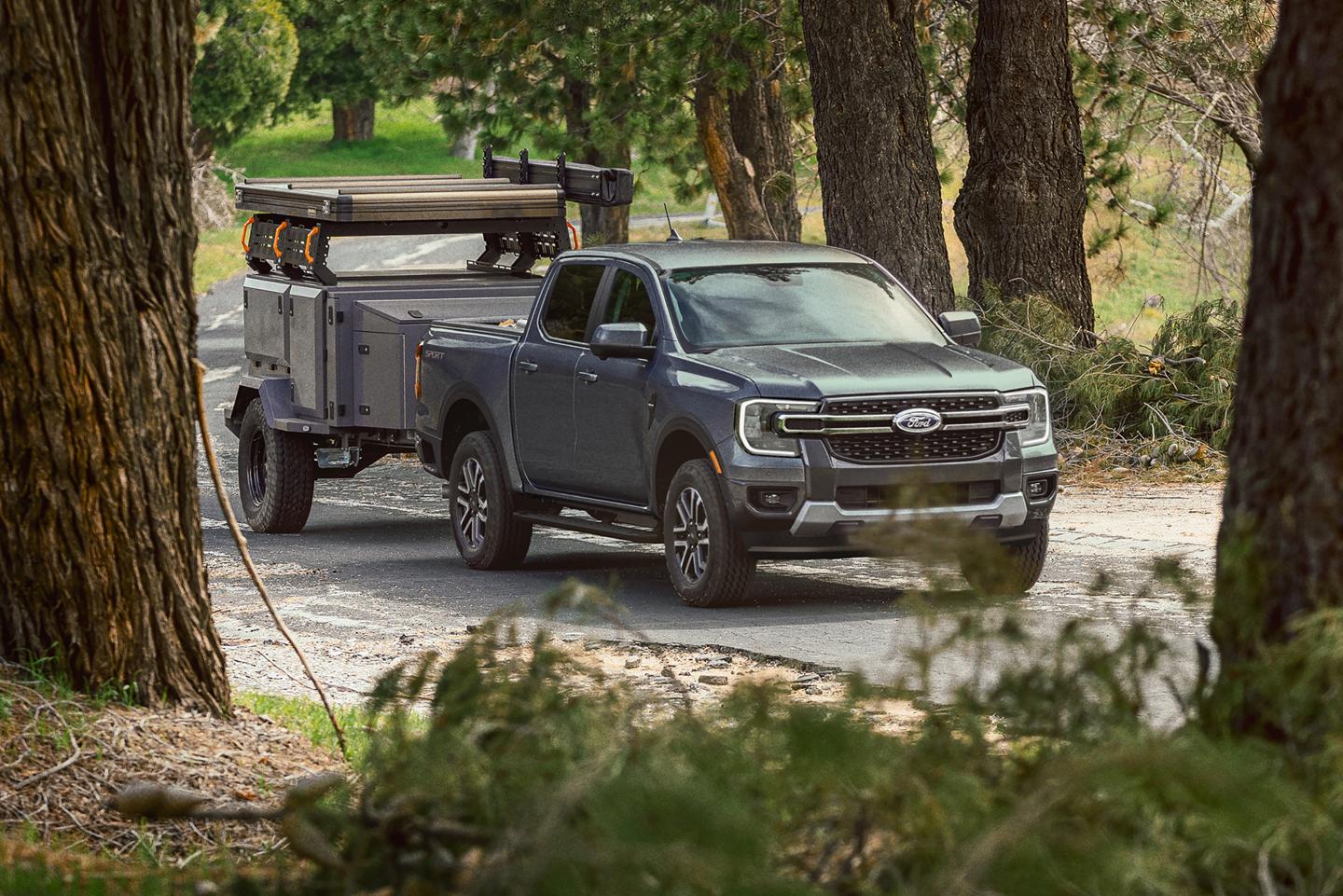 A 2026 Ford Ranger® truck pulling a large trailer on a paved road