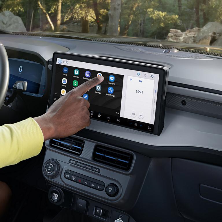 A Person using the 13.2" centre display
