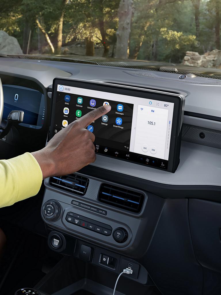 A person operating the centre display on a 2026 Ford Maverick® pickup