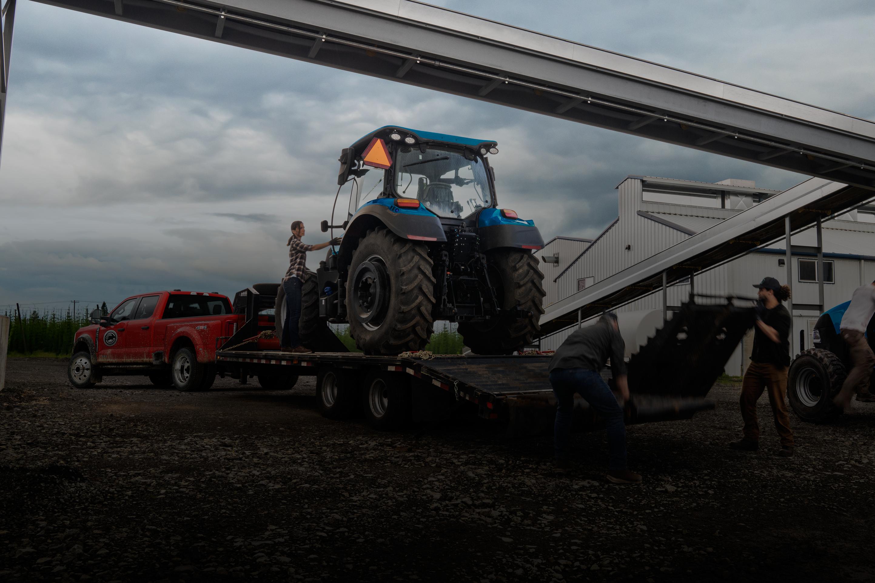 2026 Ford Super Duty® F-450® XL pulling a trailer carrying a large tractor