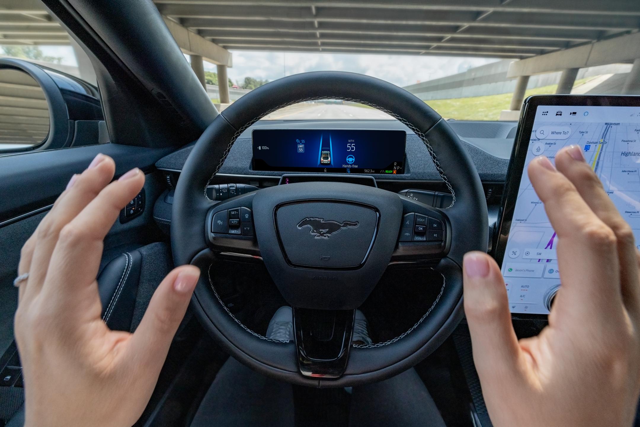 Person driving a Mustang Mach-E hands-free.