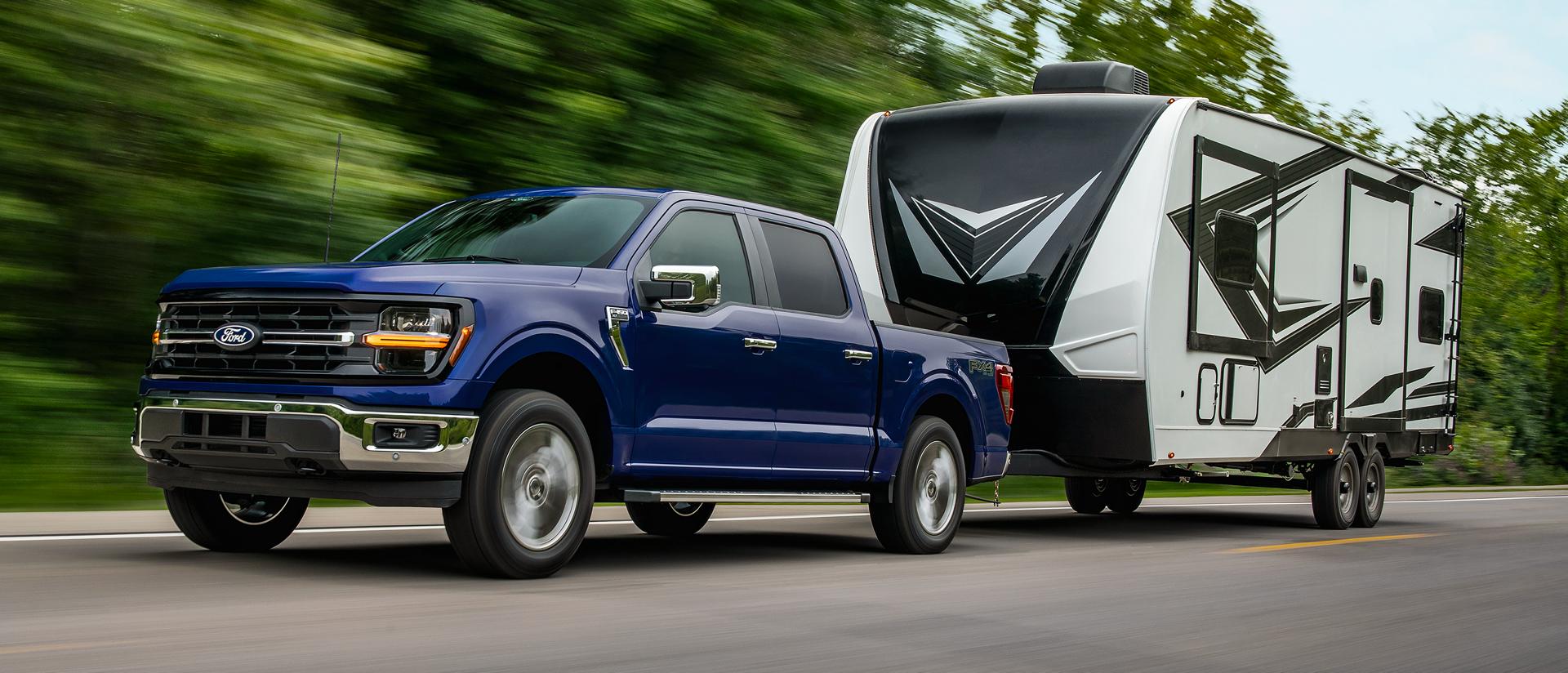 2026 Ford F-150® XL pickup in Argon Blue Metallic pulling a camper