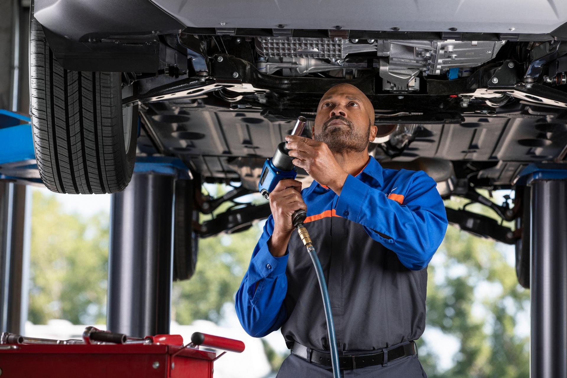 A Ford Service garage with a man performing maintenance on a Ford vehicle