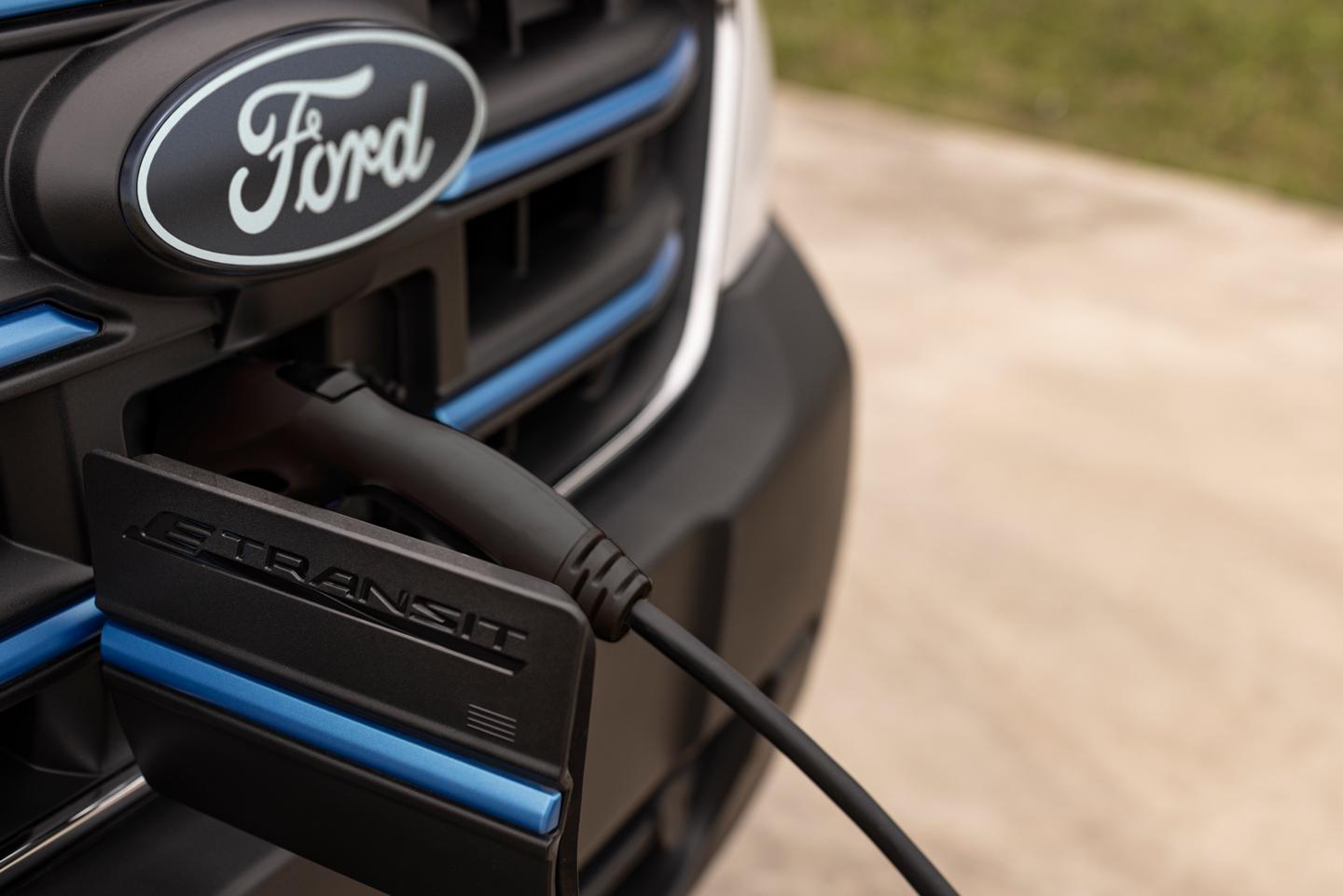 The front grille of a 2026 Ford E-Transit™ while plugged in to charge
