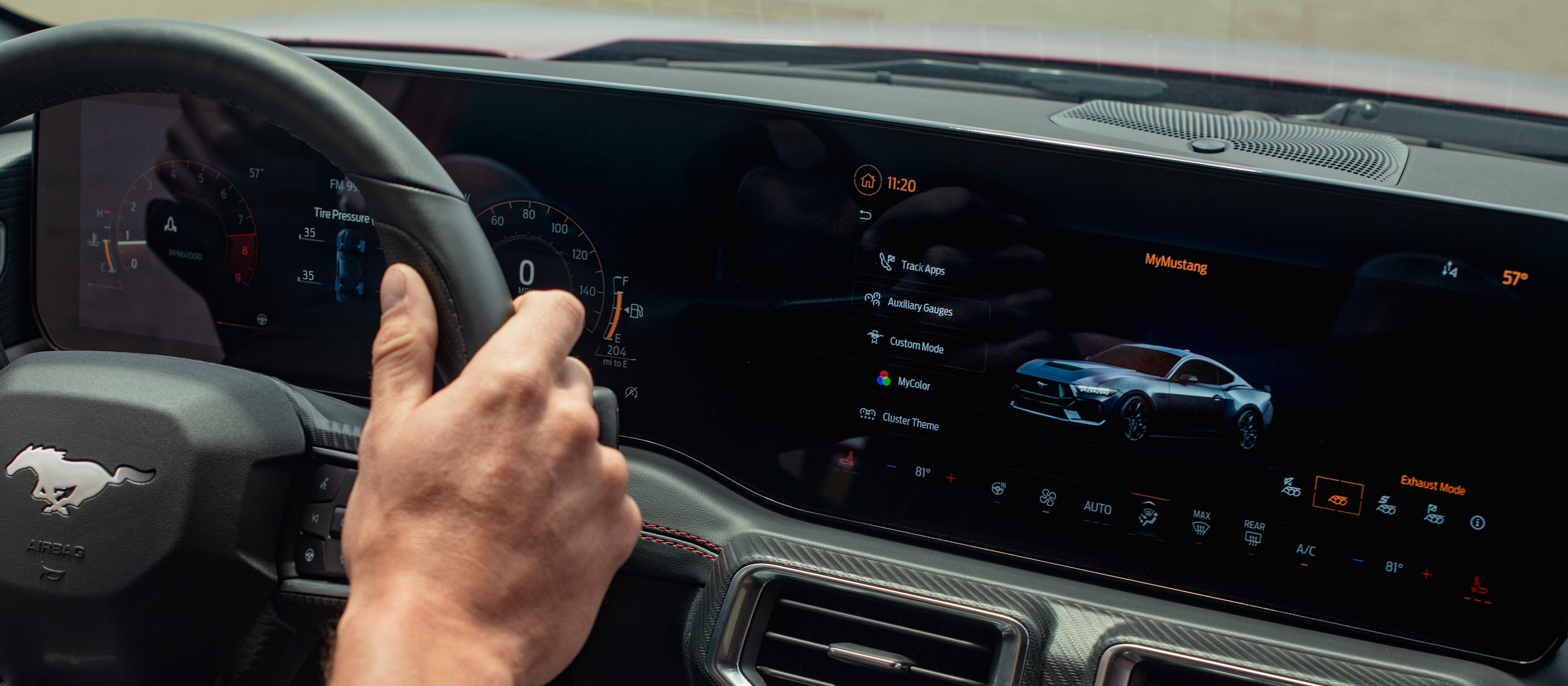 Person driving a 2025 Ford Mustang® model with the available 13.2" centre touchscreen