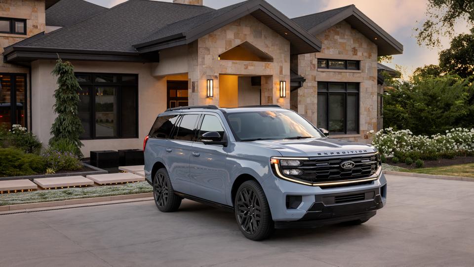 2026 Ford Expedition® Platinum™ SUV with available Stealth Performance Package parked in a home driveway