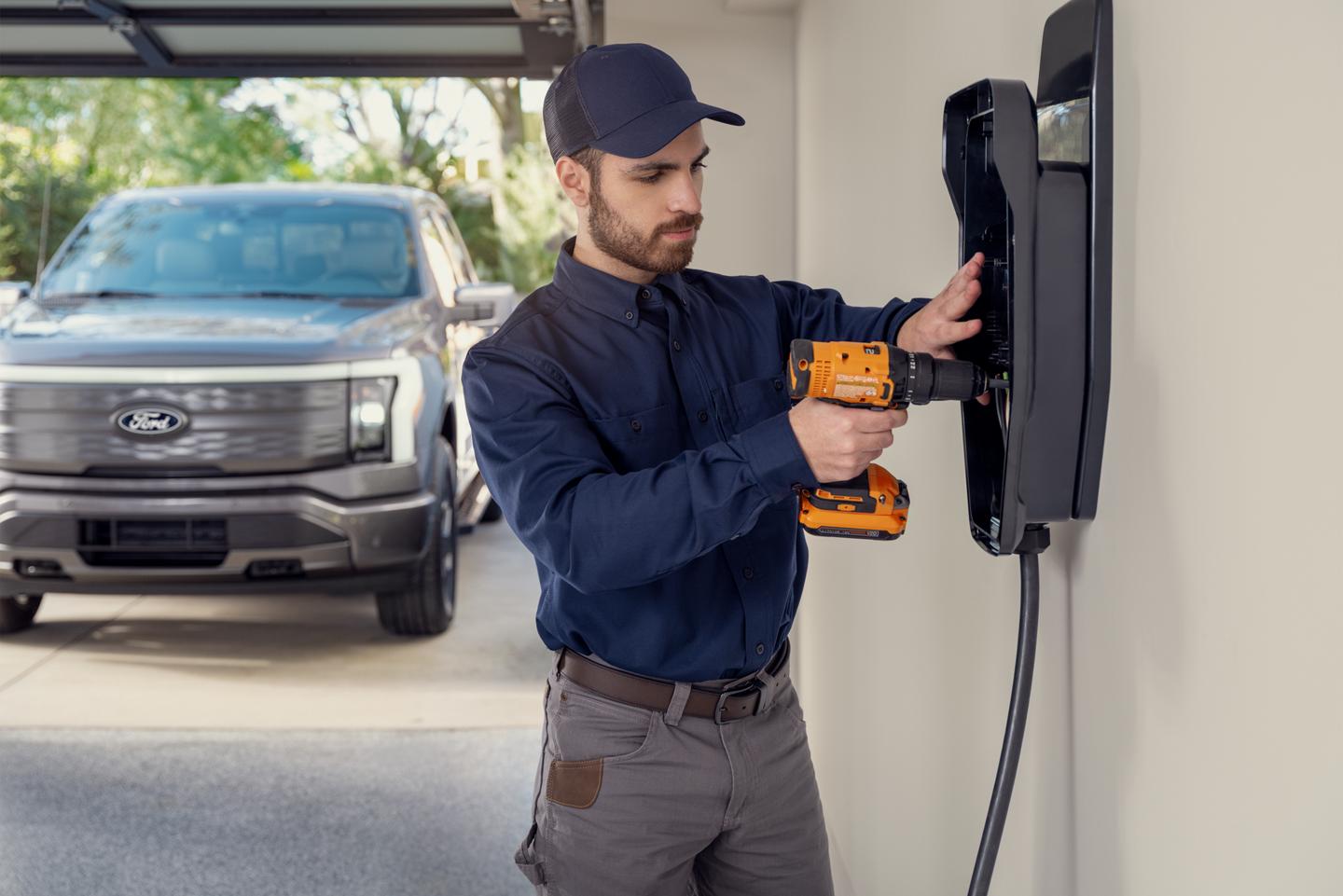 Service technician installing a home charger in a residential garage.