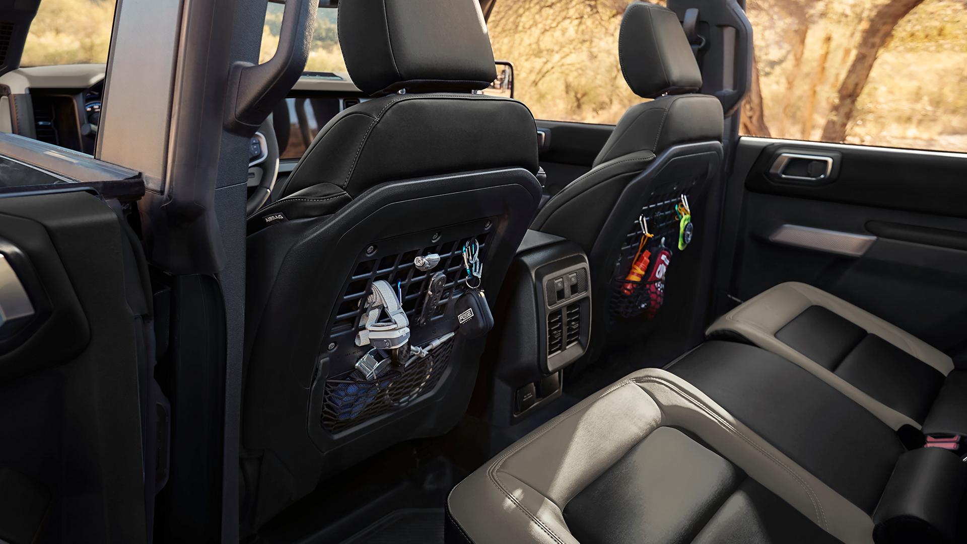 The rear seat area of a 2026 Ford Bronco® SUV, showing the MOLLE panels in the front seat backs