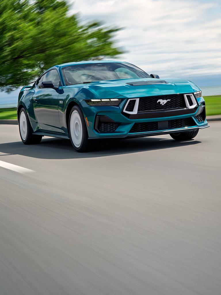 2026 Ford Mustang® GT Premium fastback model with FX Package being driven near a lake