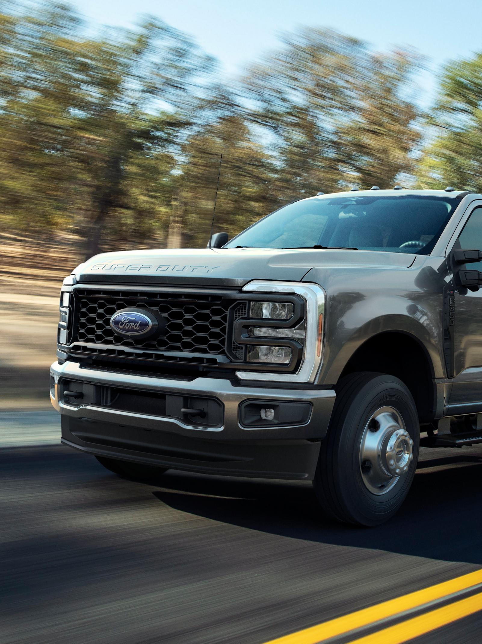 2026 Ford Super Duty® F-250® XL with the STX® Appearance Package in Carbonized Grey driving on a paved road