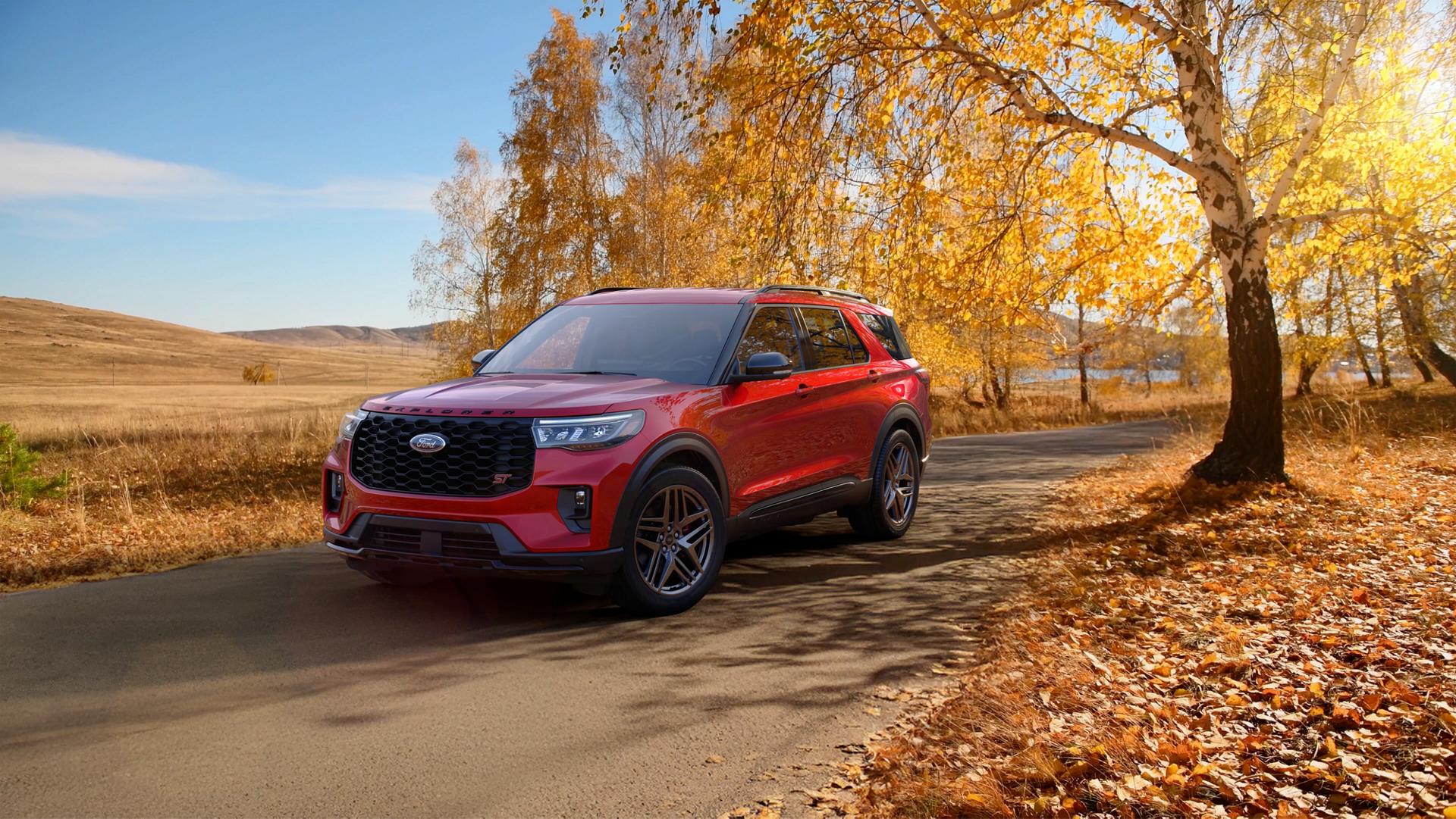 A 2026 Ford Explorer® SUV on a road next to a field in the fall