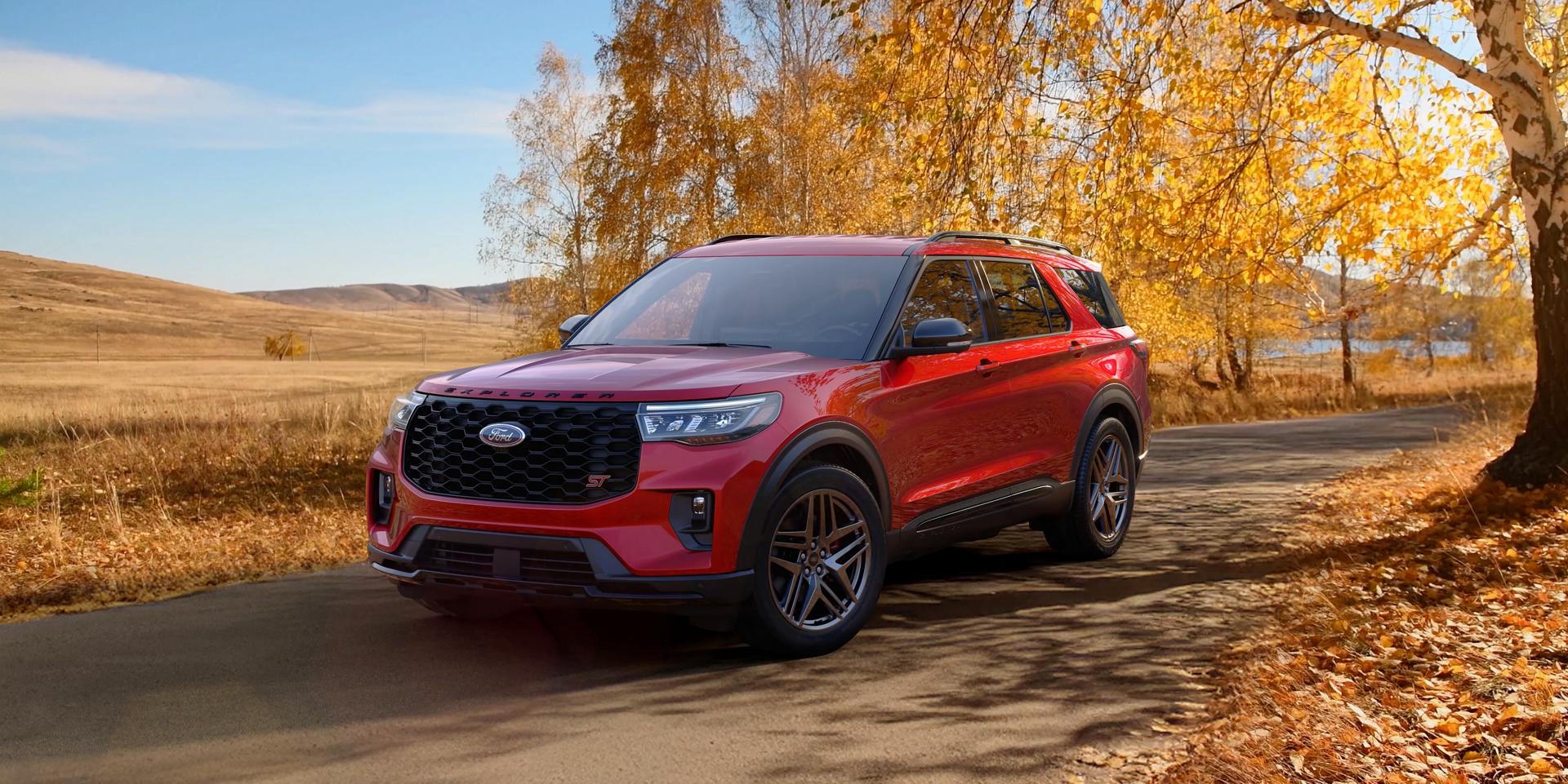 A 2026 Ford Explorer® SUV on a road next to a field in the fall