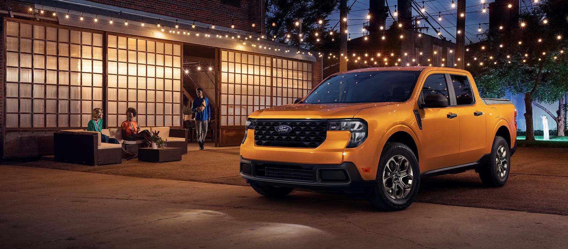 2026 Ford Maverick® pickup parked under strings of lights at night