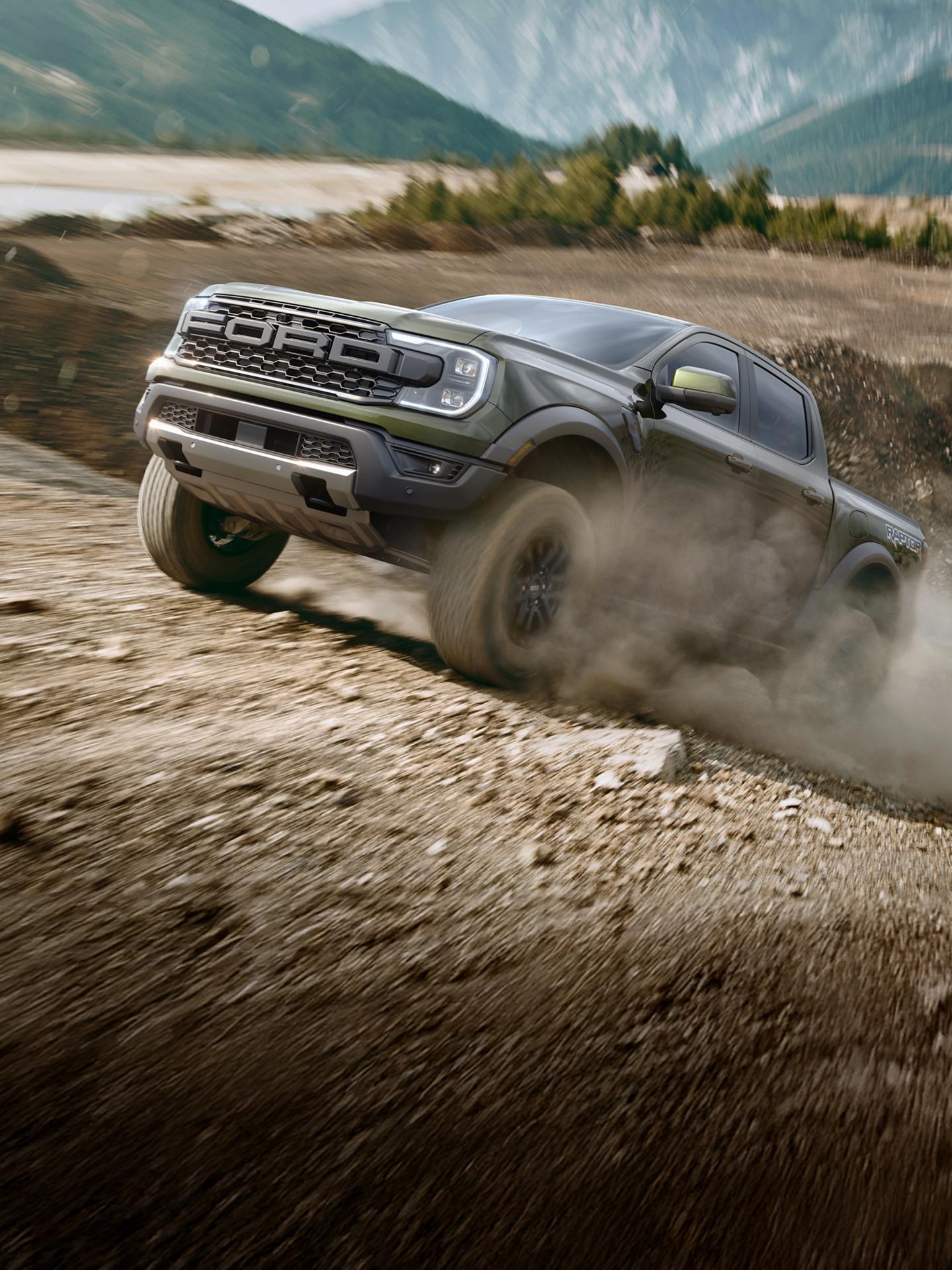 2026 Ford Ranger Raptor® truck being driven over rough terrain at high speeds in a mountainous desert