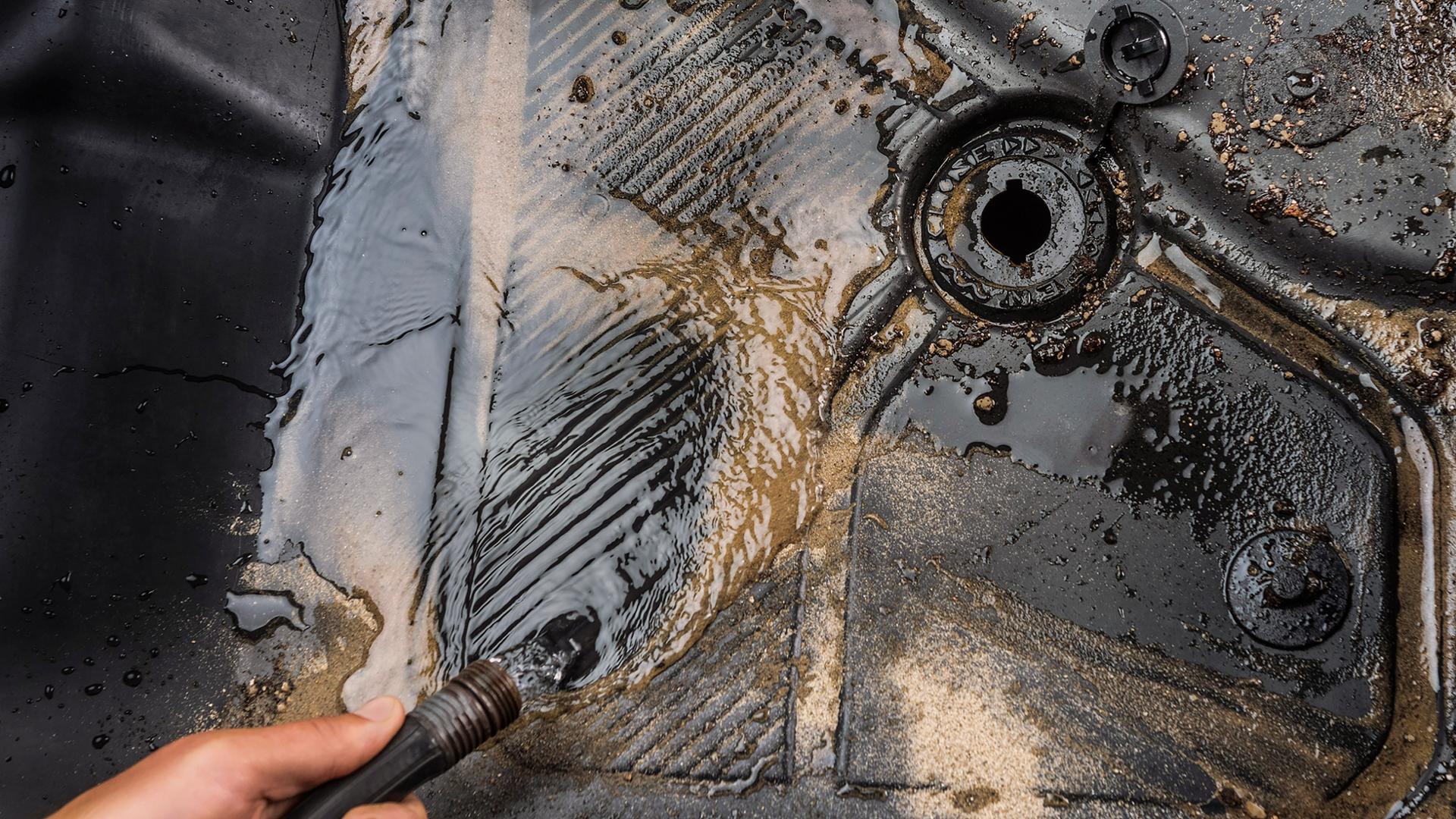 Muddy water running out of the drain plug in the floor mat of a 2026 Ford Bronco® SUV