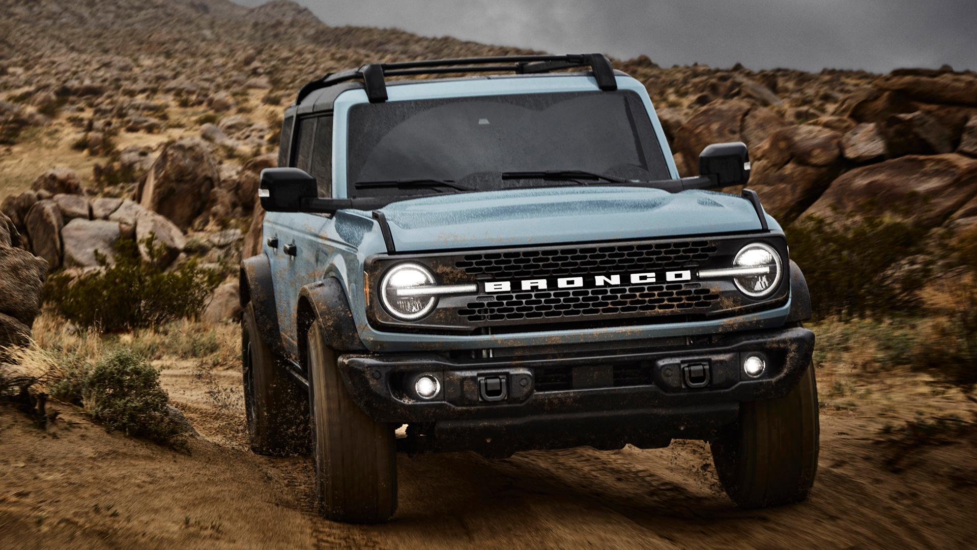 A 2025 Ford Bronco® SUV driving on a dirt trail in the high desert