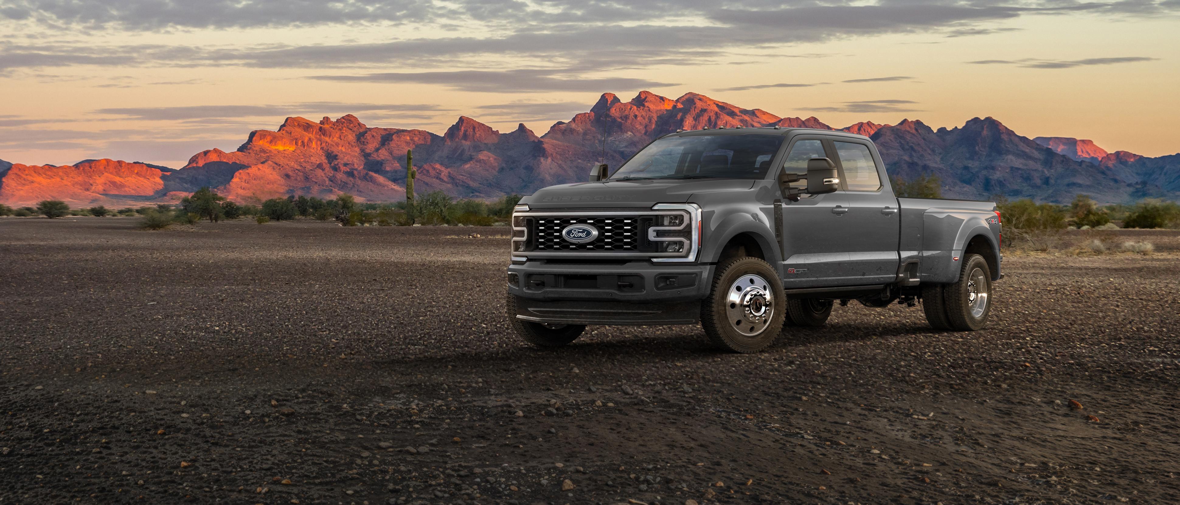 2027 Ford Super Duty F-450 Platinum truck parked on a dirt road in the mountains