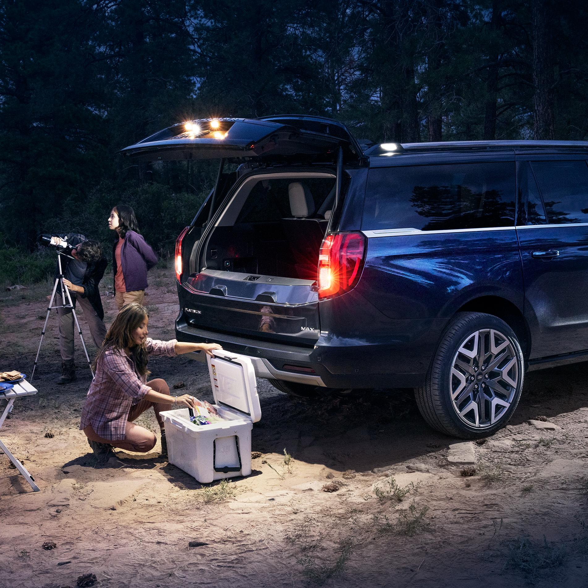 2026 Ford Expedition MAX® Platinum™ SUV with available 360-degree Zone Lighting and features with people nearby